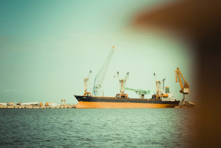 Cargo vessel at anchor near port waiting for berth