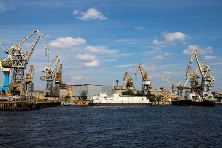 Commercial port with cargo cranes and vessels